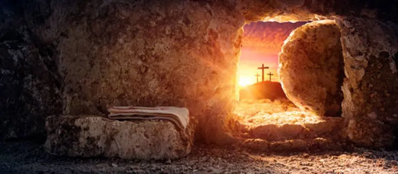 The empty tomb at sunrise, with three crosses on the hill beyond